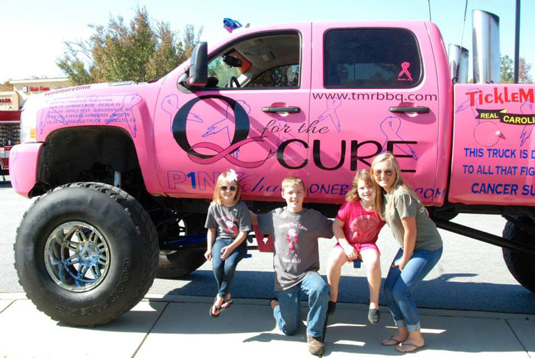 children posing with truck